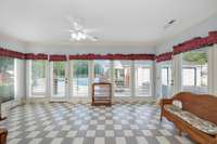 Sunroom- tile flooring, crown molding, ceiling fan