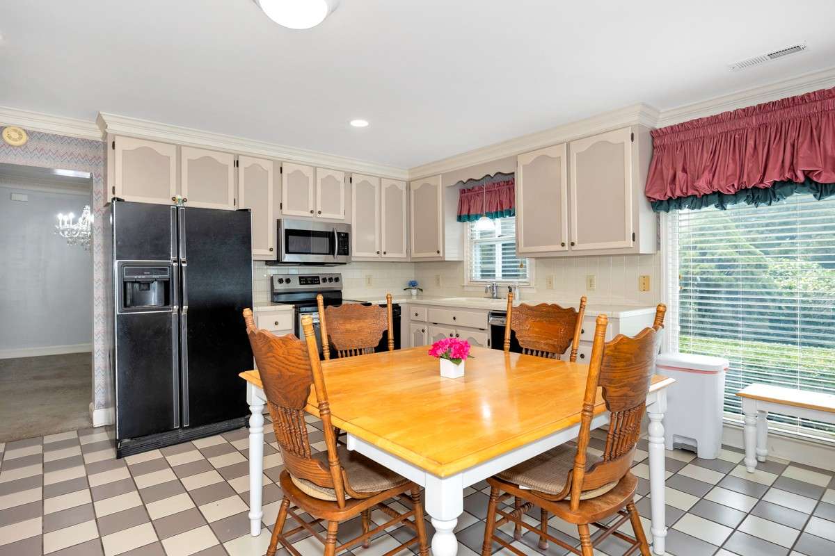 Kitchen- tile flooring, tile backsplash and countertops, crown molding