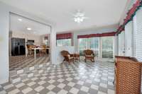 Sunroom- tile flooring, crown molding, ceiling fan
