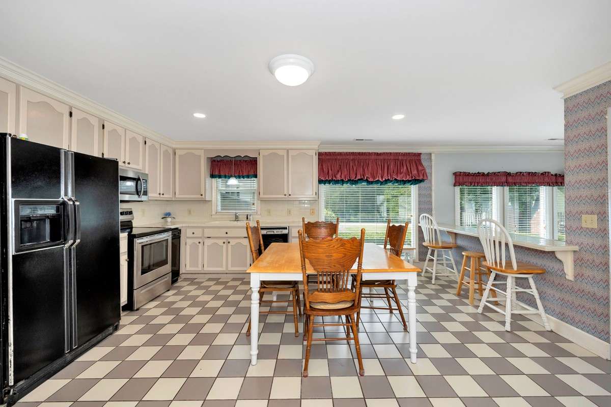 Kitchen- tile flooring, tile backsplash and countertops, crown molding