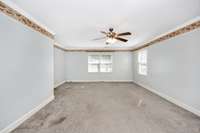 Bedroom- carpet, crown molding, ceiling fan