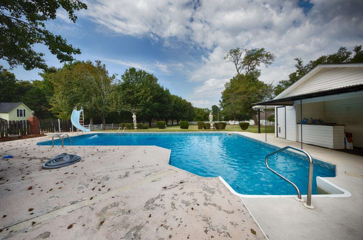 Inground pool- two ladders in deep end, steps in shallow end, water slide