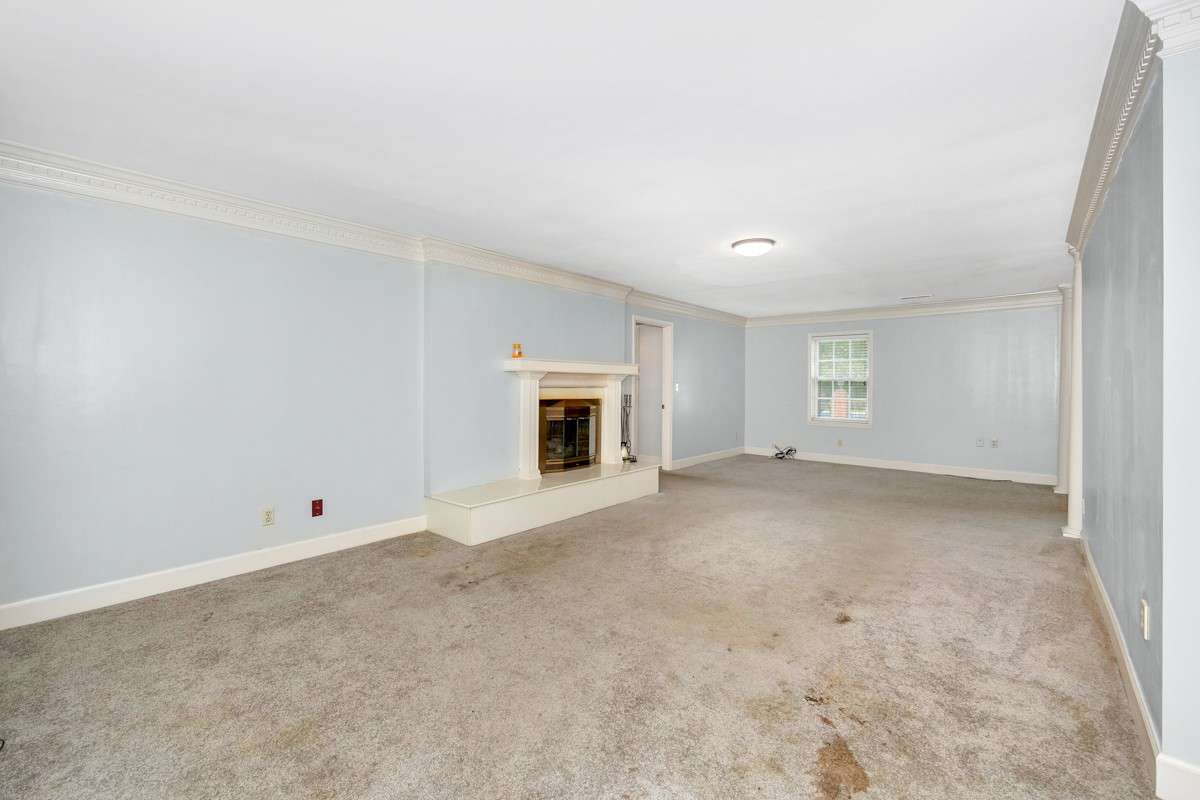 Living Room- carpet, gas log fireplace, crown molding