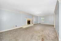 Living Room- carpet, gas log fireplace, crown molding
