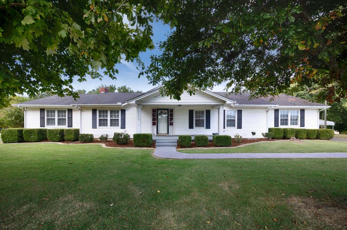 Front of house- Simple landscaping, covered porch, vinyl siding