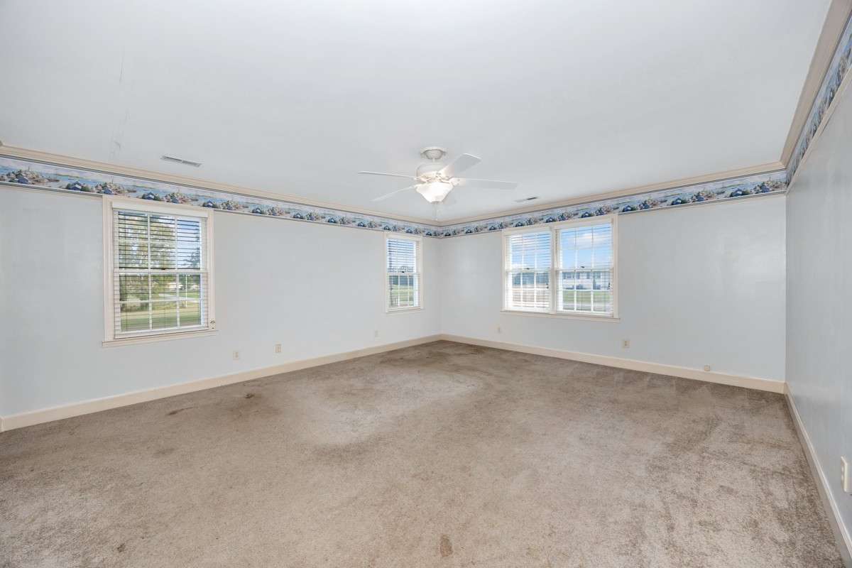 Bedroom- carpet, crown molding, ceiling fan