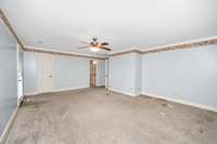Bedroom- carpet, crown molding, ceiling fan