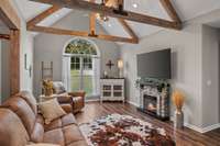 Cyprus beams, arched window. Electric fireplace conveys...