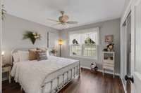 This bedroom features beautiful shiplap on the interior wall and double mirrored closet doors...