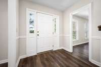 Entrance foyer with entries to the large family room to the left and the spacious den with fireplace to the right.