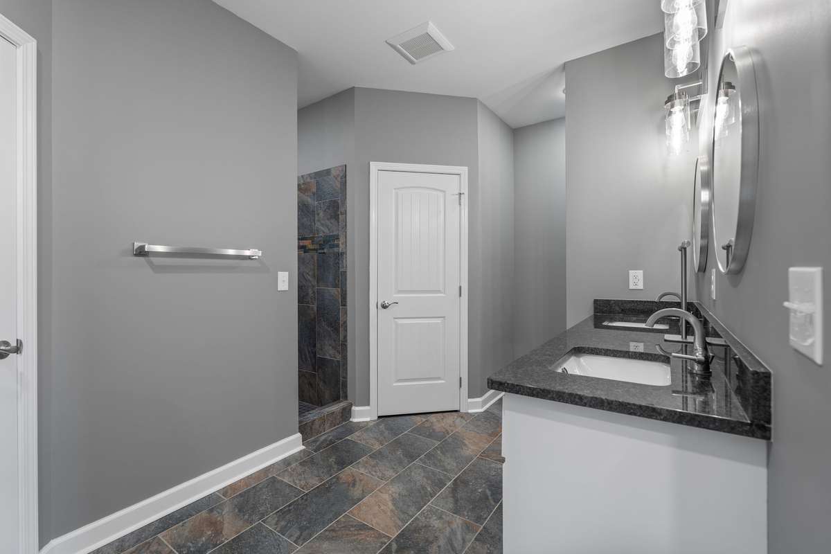Awesome primary bathroom with double vanities, large walk in shower, 2 separate closets!