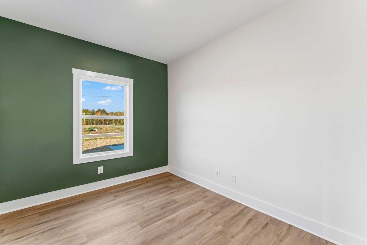 The office is located just off the living room and kitchen featuring a basil-green accent wall. It will be the envy of zoom call backgrounds!