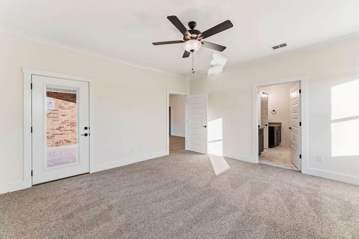 The large primary bedroom is located just off the living room with a private access to the covered back patio.