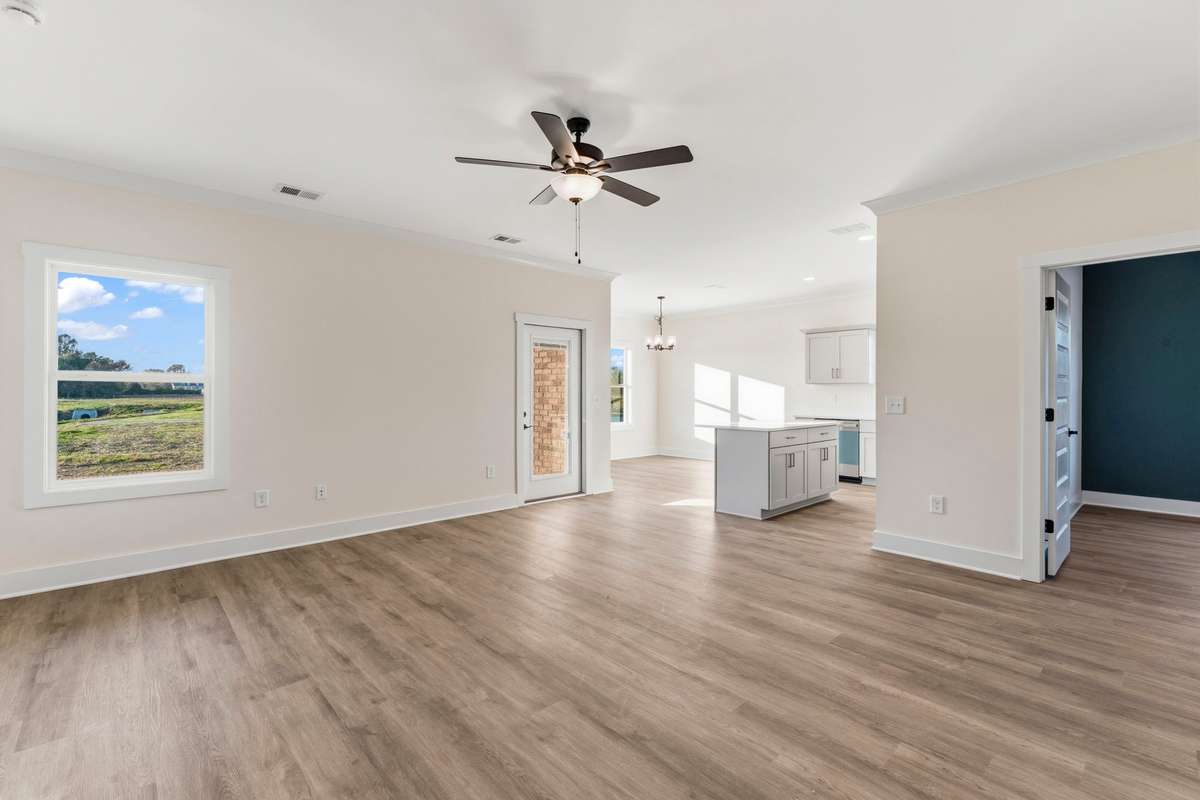 When entering the living room your views include the large pond, kitchen and green-with-envy office!