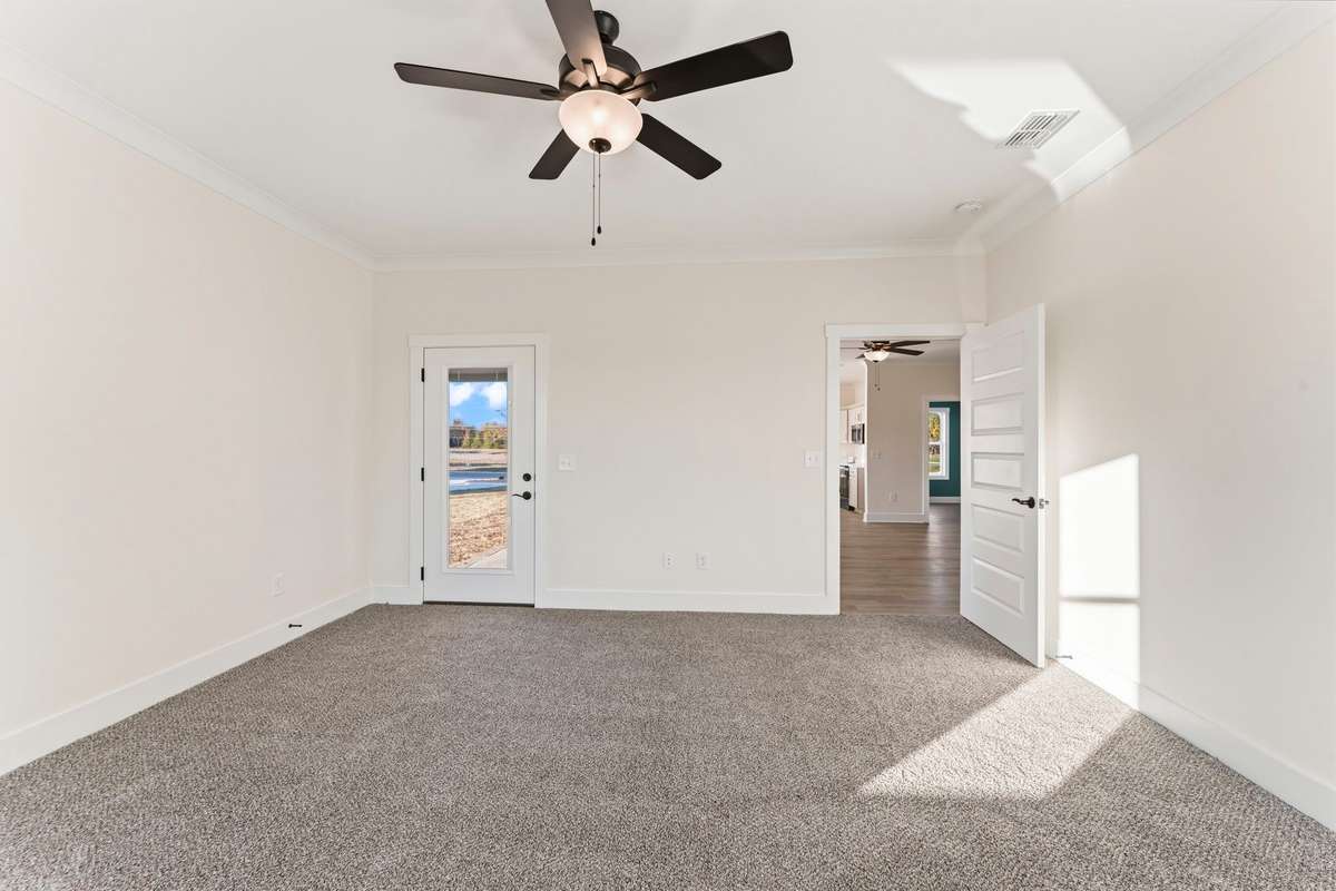 From the primary bedroom you can see the back patio, living room and a peep of the office and kitchen.