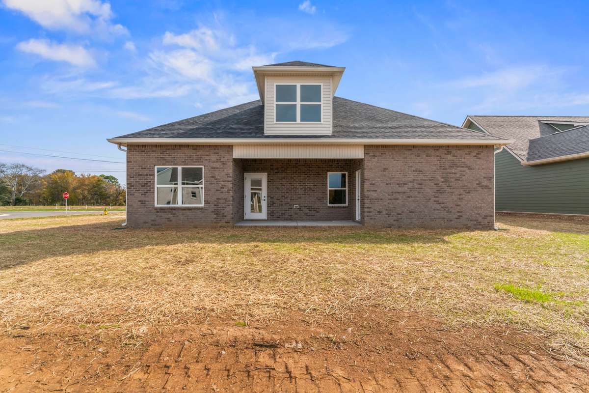 The covered back porch is accessible from the living room as well as the primary bedroom.