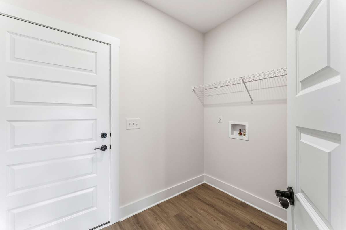 The laundry room is located just off the garage with shelving to make laundry-day done easy!