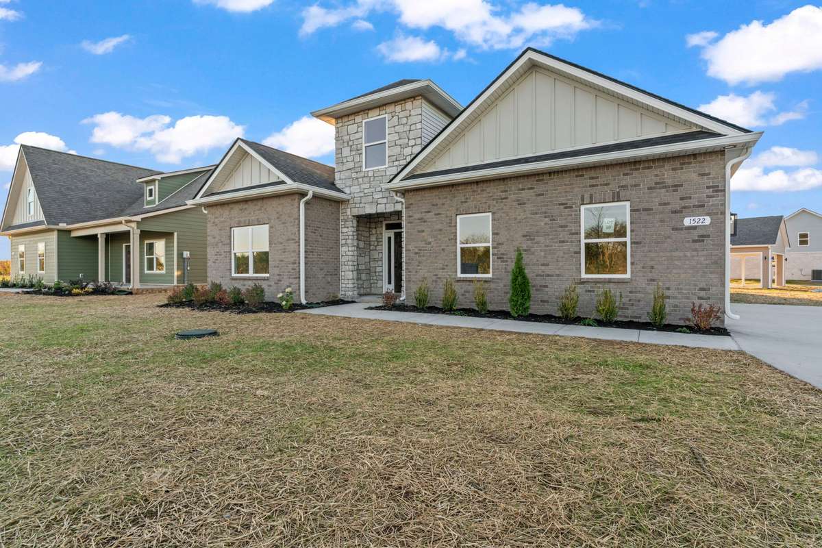 The front landscape varies throughout the neighborhood. This home offers a mix of greenery, trees and flowering plants!