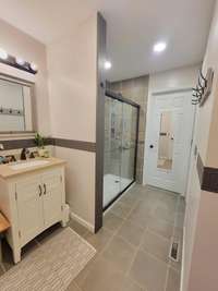 Another view of the primary en-suite bathroom.  You can see the amazing tile shower and the large walk-in closet just past it.