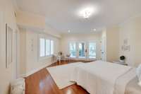 The fifth bedroom is on the bottom level of the home, making this an idea in-law/nanny suite. There's a private bath and doors to a private patio with a separate entrace.