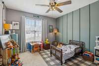 Bright and cozy guest room with ample storage and a modern accent wall