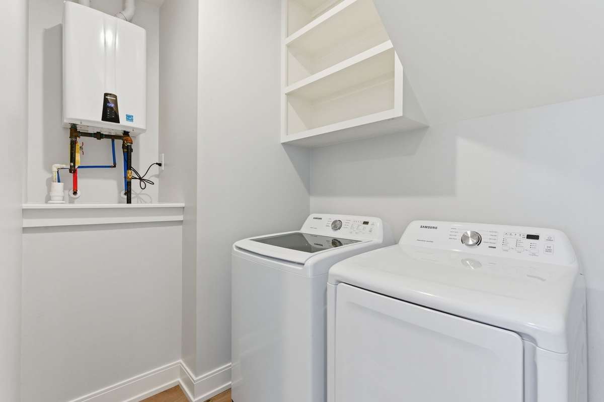Laundry Room with shelving + tankless water heater.