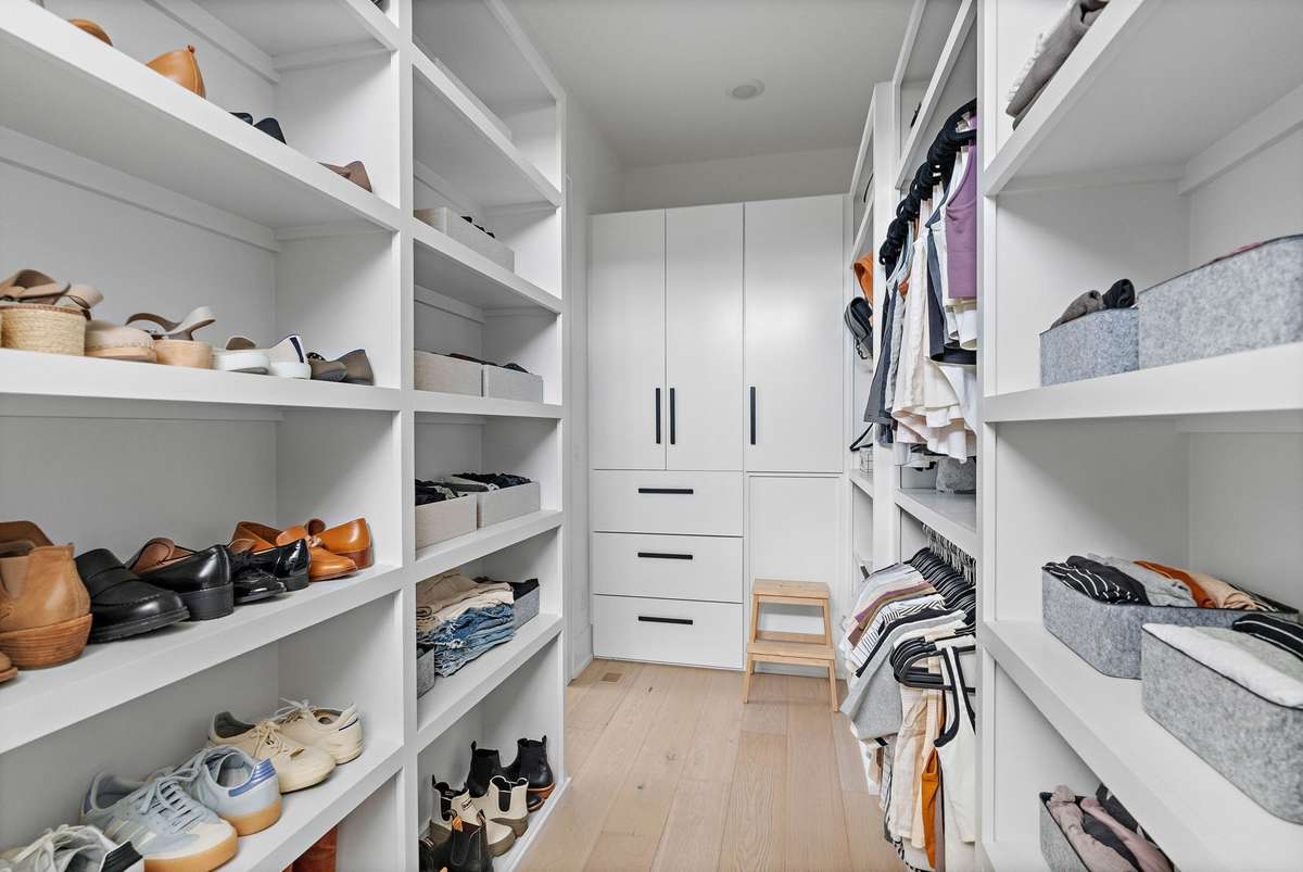 The primary closet is what dreams are made of with built-in cabinetry and drawers all designed for maximum storage.