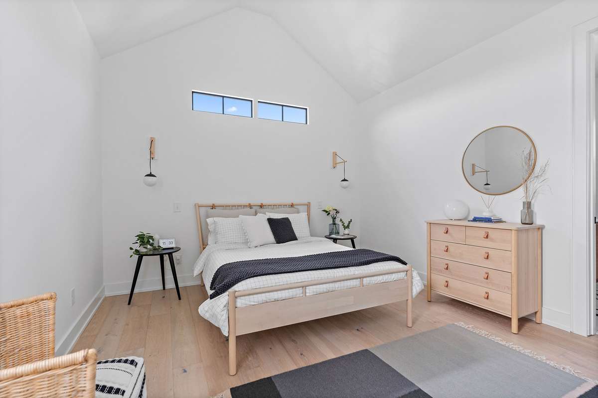 Upstairs Primary also features vaulted ceilings + gorgeous en suite bath.