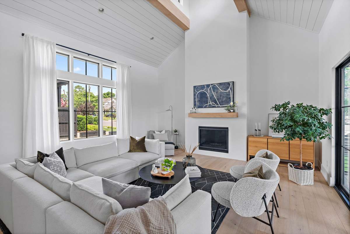 Living Room is extremely spacious yet also cozy with a combination of soaring ceilings, exposed beams and fireplace.