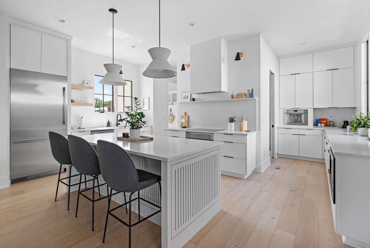Island seating, vented hood, Thermador appliances + an abundance of counter space.