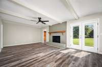 Great room features a wood burning fireplace and french doors leading to the patio.