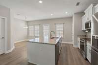 Alternate view showing the eat-in kitchen area for additional seating and the back door leading to your back patio and garage.