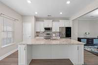 Alternate view of your kitchen with a stove that has an airfryer and a fridge with the window view!  The Chef has everything they need for creating!  Builder grade appliances replaced with top of the line!