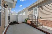 Back private courtyard patio fenced with a gate leading to a walkway and driveway as well as an entrance to your private two car garage.  Just pressure washed!
