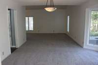 This photo shows the new carpet throughout this large dining room for your family and friends.