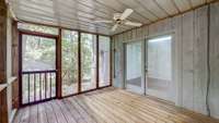 Another view screened porch to sit and watch the wildlife. With a ceiling fan and white Christmas lights outlining the ceiling, this space can be enjoyed day and night.