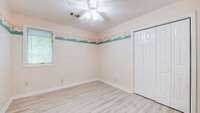 Used as a hobby room, this room has a closet and could be used as a 4th bedroom. New laminate flooring and ceiling fan lighting.