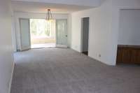 This is your dining room, open to the Florida room, with a doorway to the massive kitchen opposite a large bay window. (bay window not seen in this photo, but you can see the light coming in)