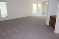 New Carpet has been installed!!  This massive living space opens to the formal dining room.