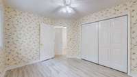 Bedroom 3 also has a ceiling fan, lots of closet space and new flooring.