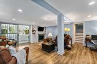 Lower level den/gathering room features luxury vinyl plank flooring.