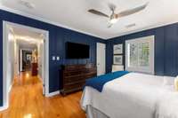 View of the hallway hardwood from the bedroom. Note the ceiling fan in the bedroom.