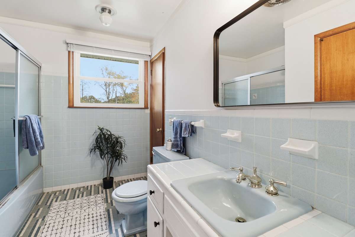 Stairs leading to the 3 bedrooms and full bath.