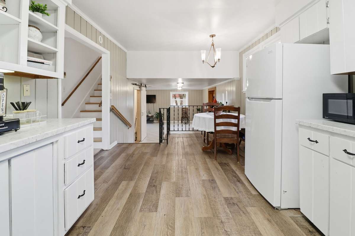 Bright kitchen view looking down into the den area.