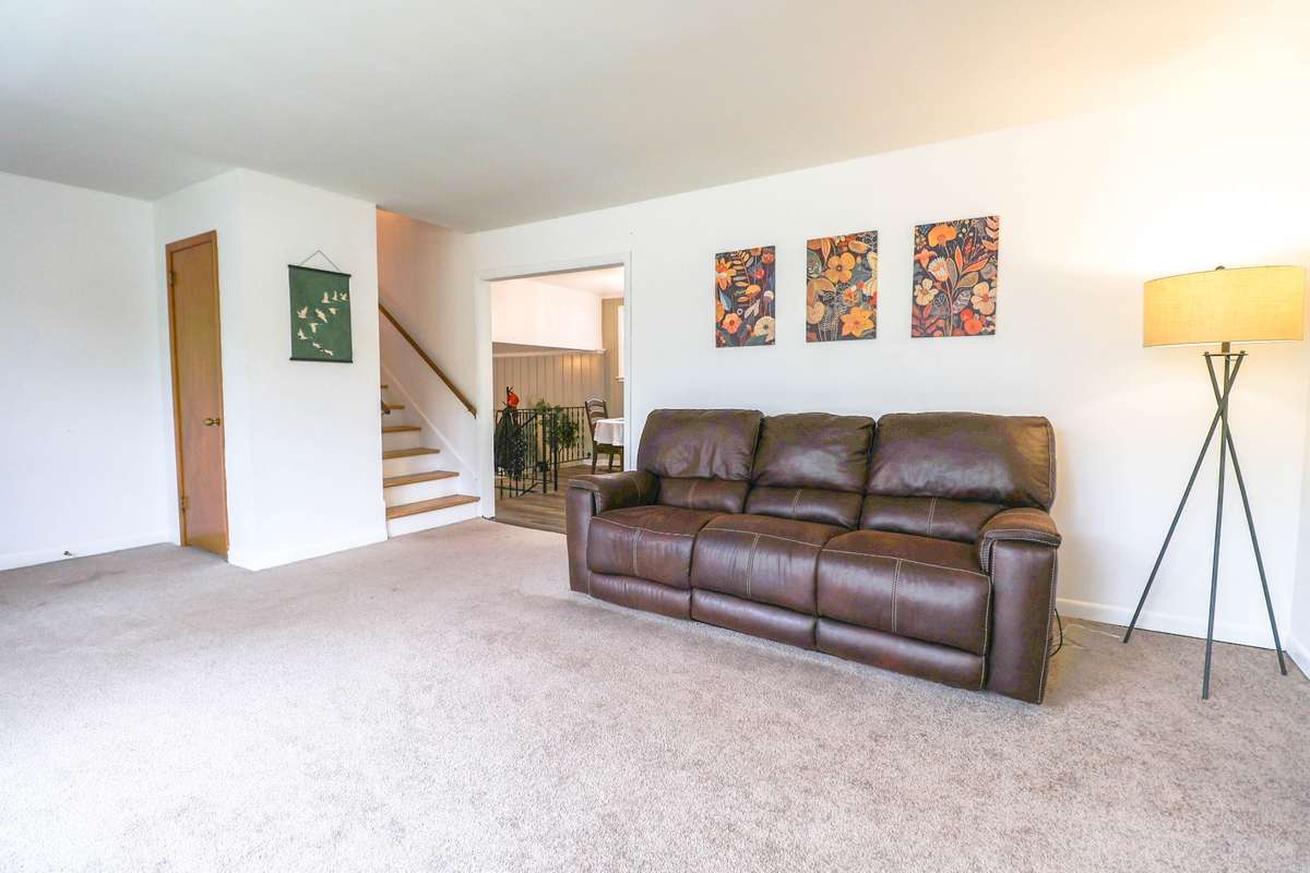 Living room with a coat closet.