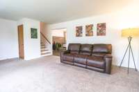 Living room with a coat closet.
