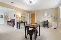 Formal dining room, currently being used for office and gaming room. So many options with this room, would make a great space for home schooling. Through the wooden door is a large utility room that could be used for a pantry or mudroom.