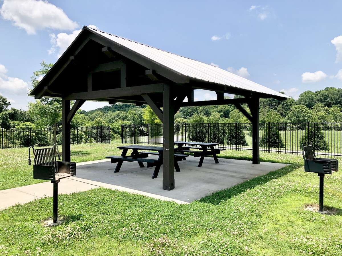 The neighborhood features a beautiful pavilion area complete with picnic tables and barbecue stands—perfect for weekend cookouts, gatherings with friends, or simply enjoying the outdoors.
