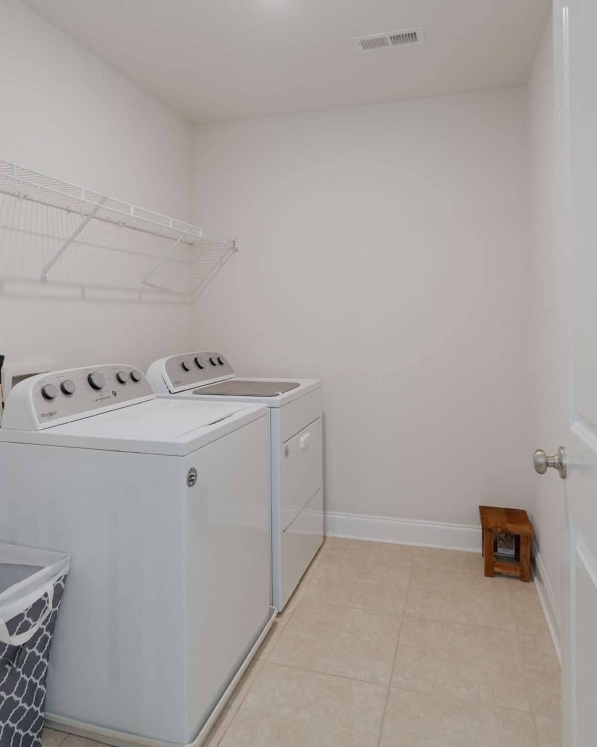 Large walk-in laundry room with tile flooring.