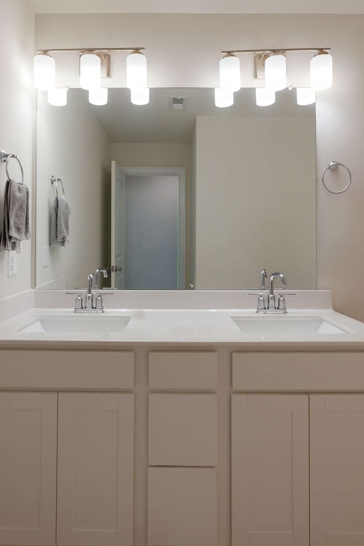 Upstairs bathroom with double vanity and shower tub combo.